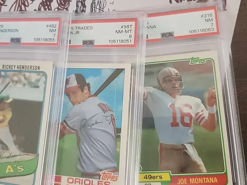 PSA-graded rookie-era cards from a purchased collection: a 1980 Rickey Henderson, a Cal Ripken Jr., and a 1981 Joe Montana
