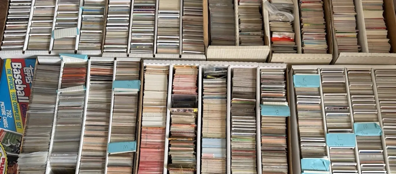 Rows of long boxes packed with sorted baseball commons and divider tabs, with a 1992 Topps complete set box visible at the left