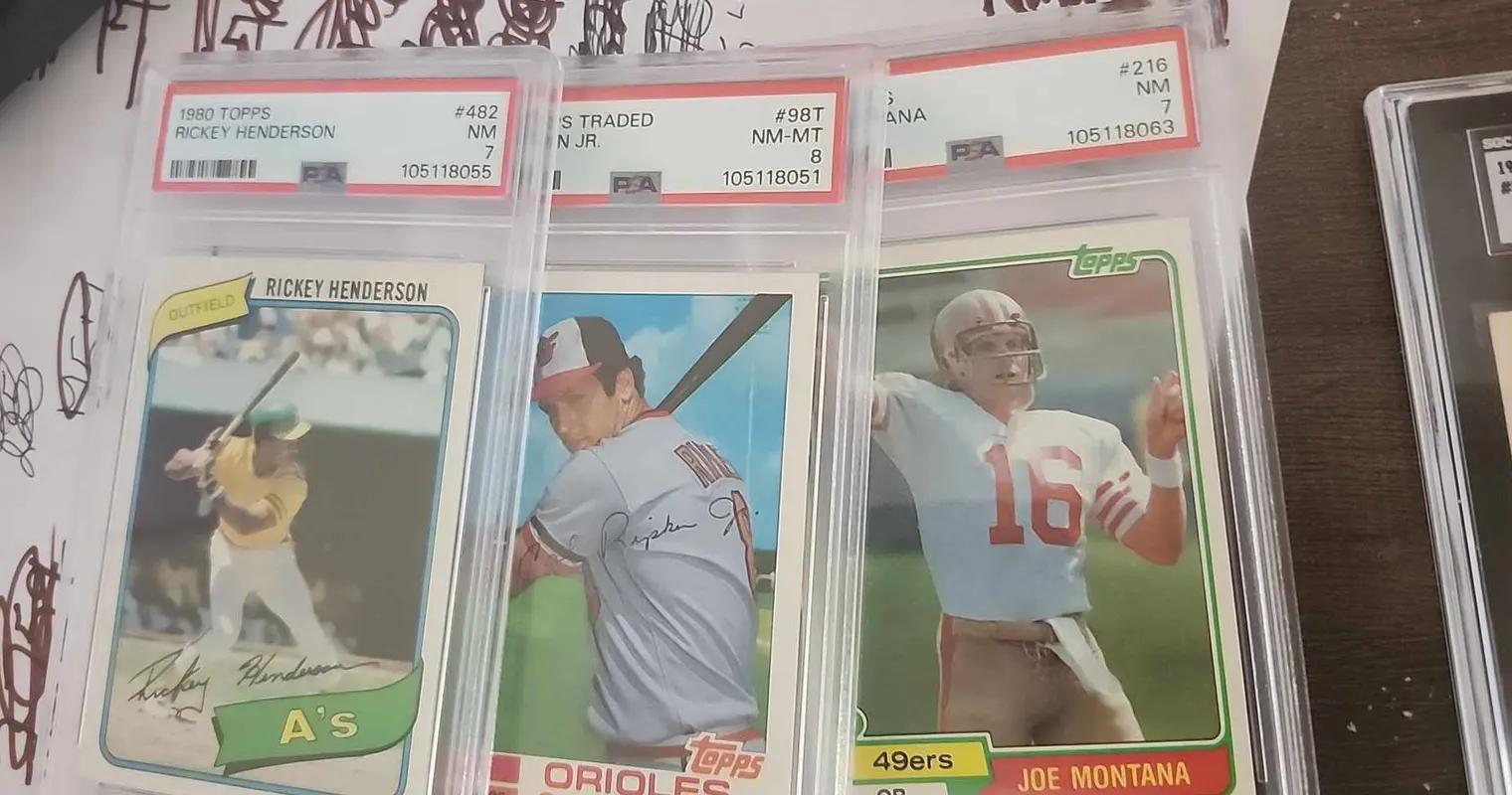 Three PSA-graded rookie-era cards from a collection we bought: a 1980 Topps Rickey Henderson PSA 7, a 1982 Topps Traded Cal Ripken Jr. PSA 8, and a 1981 Topps Joe Montana PSA 7