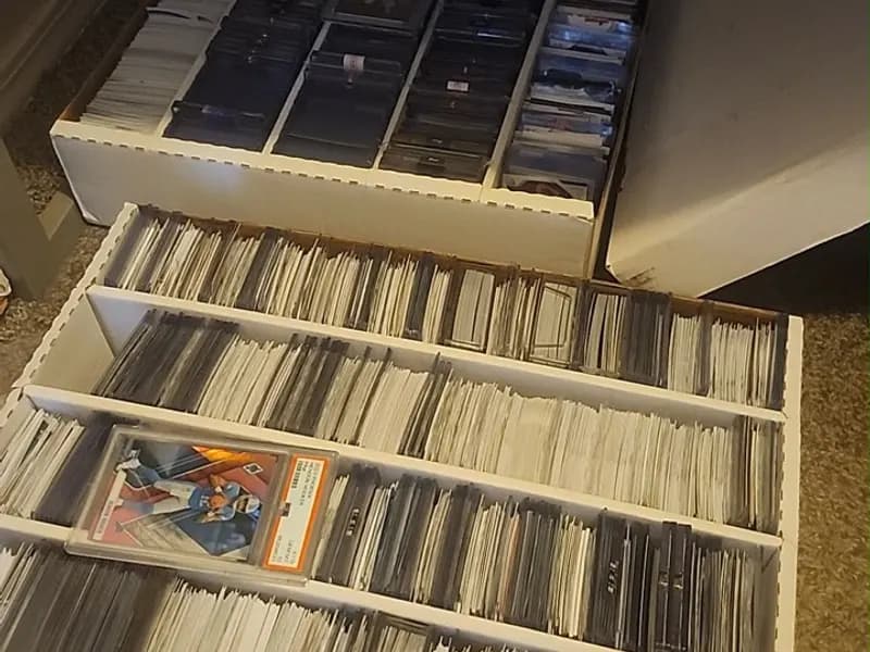 Two large boxes filled with sleeved, toploaded, and graded sports cards personally handled by iBuy.cards