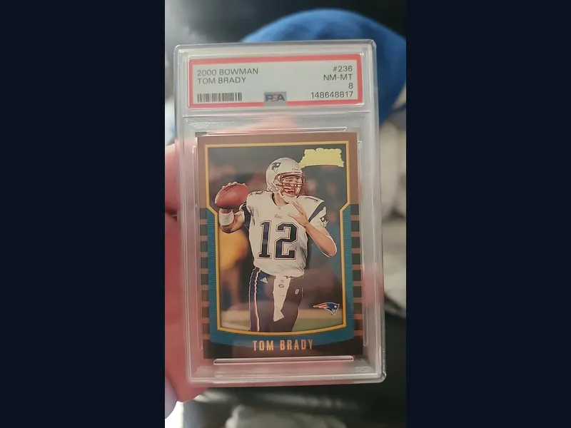 A 2000 Bowman Tom Brady rookie card graded PSA 8